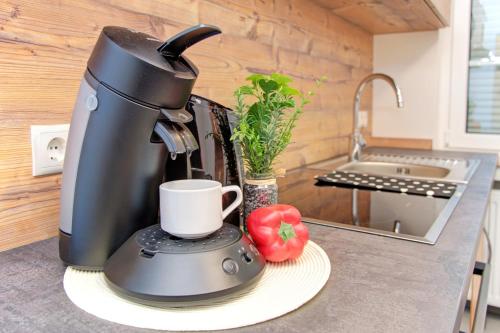 a coffee maker sitting on a counter with a cup at Apartment Landhotel Zum Storchennest in Bann