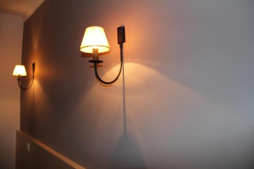 a room with two lights on the wall at Troia Hotel in Amares