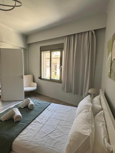 a bedroom with a large bed with towels on it at Flats 5-11 apts in Heraklio