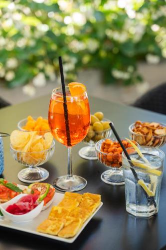 a table with a drink and a tray of food at Hotel Villa Maria Regina in Rome