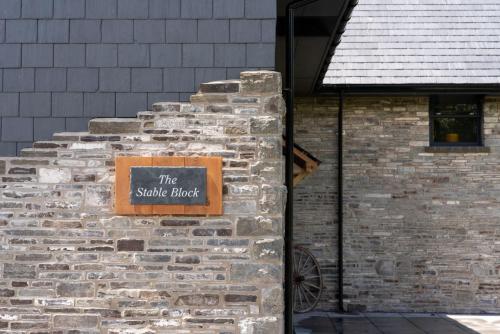 a brick wall with a sign that reads the stable block at The Big Barn in Kidwelly