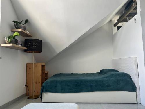 a bedroom with a bed with a green blanket at Jurgis Guest house in Kaunas