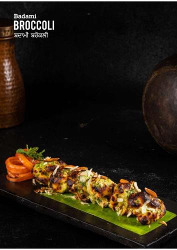 a dish of food on a plate on a table at Hotel Eternity in New Delhi