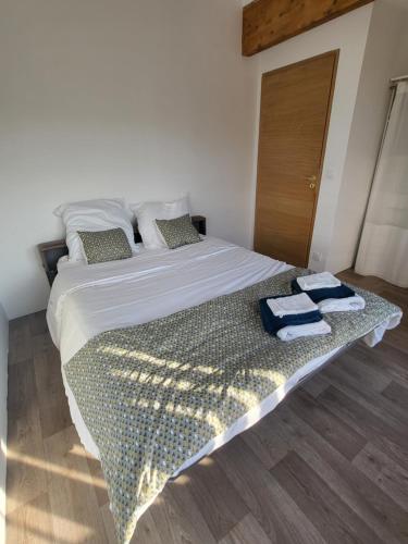 a bedroom with a large bed with towels on it at Maison familiale in Le Teich