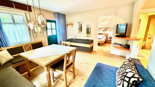 a living room with a table and a couch at Romantikchalet in Breitenbrunn