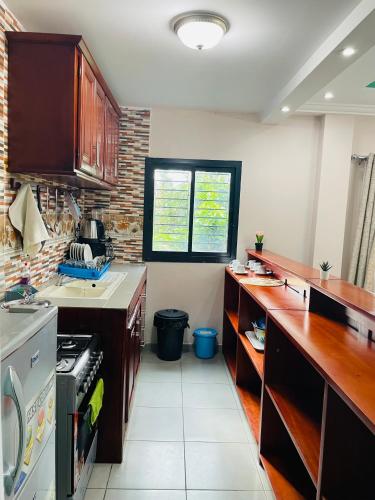 a kitchen with a counter and a stove top oven at Matera YameHome in Yaoundé