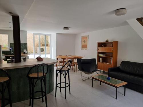 a living room with a couch and a table at Maison Cosy proche Fontainebleau in Gironville-sur-Essonnes