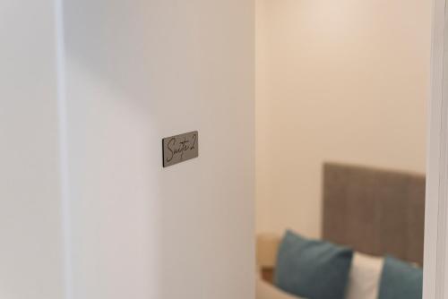 a clock on a wall in a room at Madalena Hostel e Suites in Faro