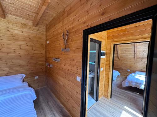 a log cabin with a room with two beds at Thethi Villas in Theth