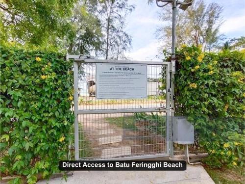 a gate with a sign that says direct access to ball french breach at By the Sea- Pool and Sea View in Batu Ferringhi