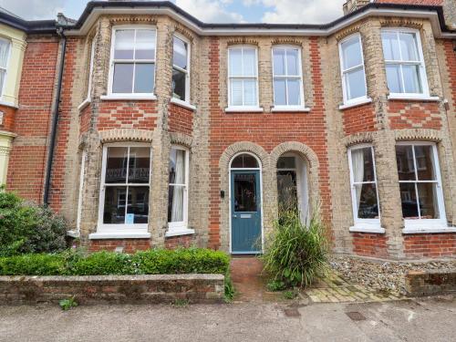 a red brick house with a blue door at 14 Dunwich Road, Southwold in Southwold
