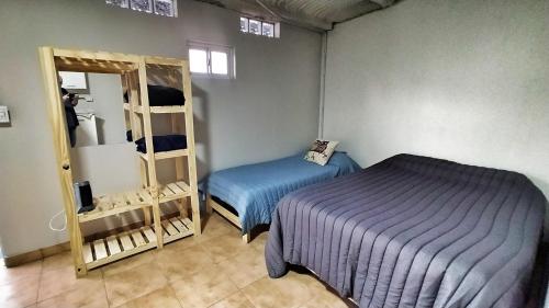 a bedroom with a bed and a mirror in a room at Saenz Peña x 4 in Venado Tuerto