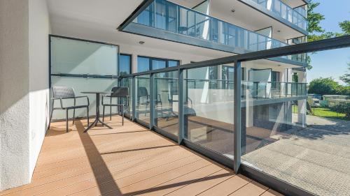 a balcony of a house with a table and chairs at Apartamenty Helski Brzeg in Hel