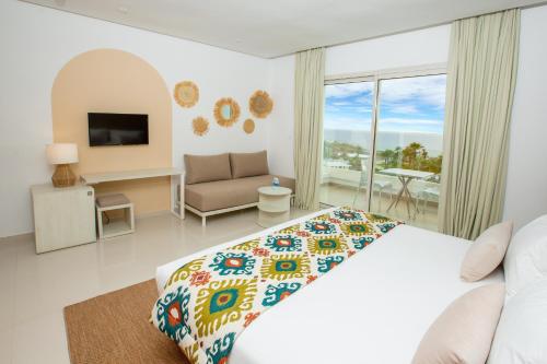 a bedroom with a bed and a living room at Lixus Beach Resort - All In in Larache