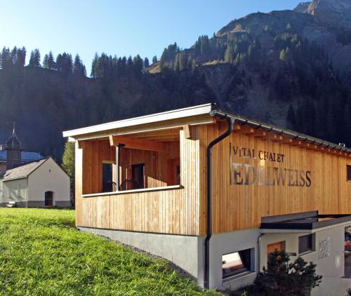 a small building with a sign on the side of it at Vital Chalets in Schröcken