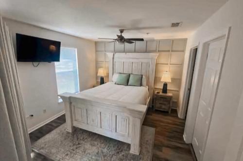 a bedroom with a white bed and a television at Gulf Island Condo 431 in Navarre