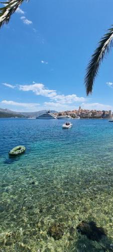 a view of the ocean with two boats in the water at Summer Park Residence Peljesac in Orebić