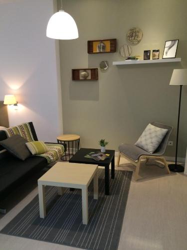 a living room with a couch and a table at Apartamentos La Estación M&S in Albacete