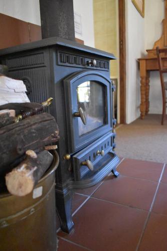 a blue stove sitting on a tiled floor in a room at Bramleigh Farm in Nottingham Road
