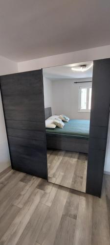 a mirror reflection of a bedroom with a bed in it at Villa Irene in Veli Lošinj
