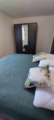 a bedroom with a large bed with pillows on it at Villa Irene in Veli Lošinj