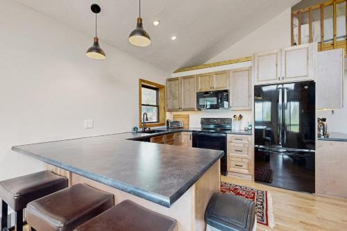 a kitchen with a large counter and a refrigerator at Diamond Ridge Getaway in Seven Devils