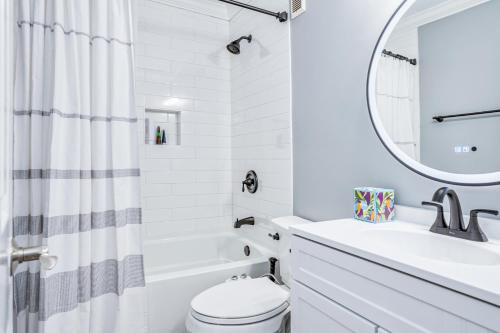 a white bathroom with a sink toilet and a mirror at Hilton Head Resort 1424 in Hilton Head Island