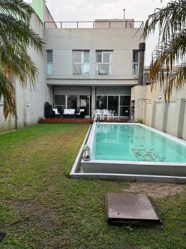 a swimming pool in the yard of a house at Casa Premium Habitaciones in Buenos Aires