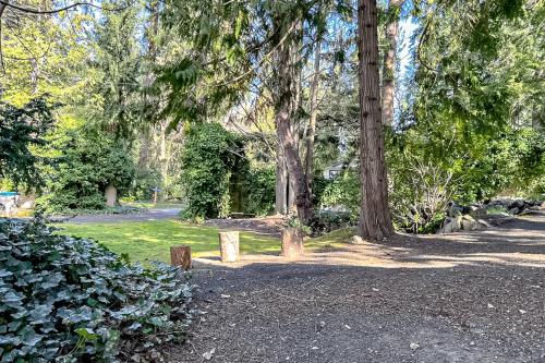 a bench in a park with trees and grass at Puget Sound Orca Retreat in Poulsbo