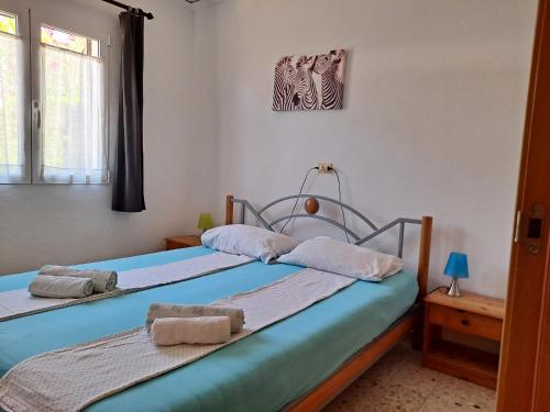 two twin beds in a room with a window at Denia El Palmar 183 in Denia