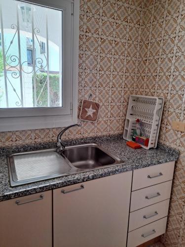 a kitchen counter with a sink and a window at Denia El Palmar 183 in Denia