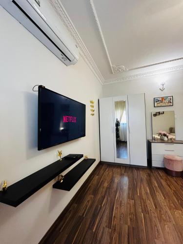 a living room with a flat screen tv on a wall at Sada Compound (Women Only) سيدات فقط in Riyadh