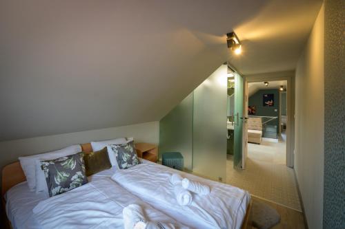 a bedroom with a bed with white sheets and pillows at Bográcsozó Vendégház in Békésszentandrás