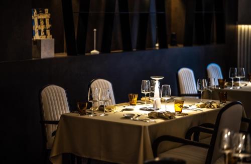 a table in a restaurant with a white table cloth at Apeiro City Avant-garde Hotel in Sarajevo