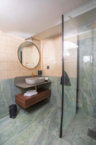 a bathroom with a sink and a mirror at Home Hotel Bryggeparken in Skien