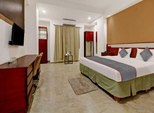 a hotel room with a bed and a television at Palette - Hotel Saket Greens in Bhopal