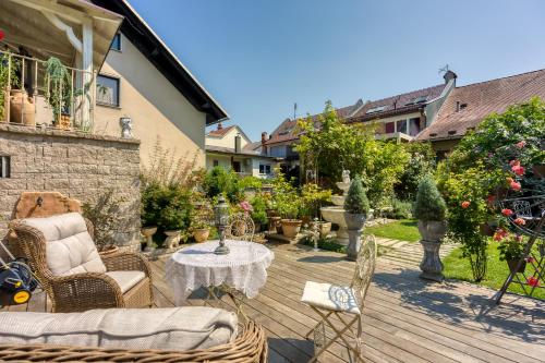 a patio with a table and chairs on a wooden deck at Royal Garden in Škofja Loka