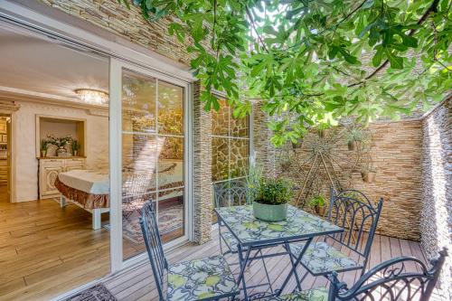 a room with a table and chairs on a porch at Royal Garden in Škofja Loka