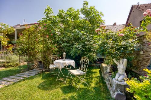 a garden with a table and chairs under trees at Royal Garden in Škofja Loka