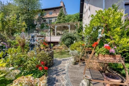 a garden with flowers and a bench at Royal Garden in Škofja Loka