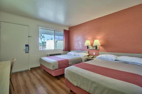 a hotel room with two beds and a window at Motel 6-Youngtown, AZ - Phoenix - Sun City in Youngtown