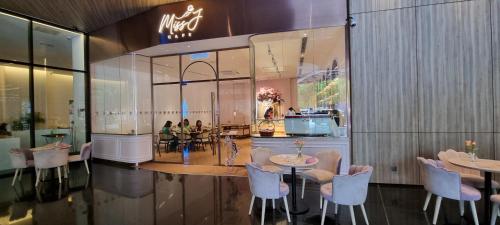 a restaurant with tables and chairs in a building at Star KLCC Elegant 2-3pax by DingDing in Kuala Lumpur