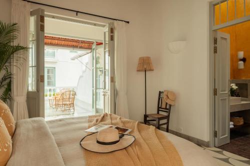 a hat on top of a bed in a room at La Rozalia, Exquisite 4 BHK Villas with Large Pool, Garden, Dedicated Caretaker, Terrace, 2 mins from the famous Dear Zindagi Road in Mapusa