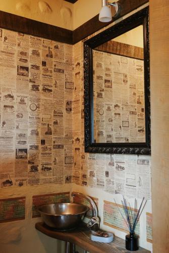 a bathroom with a sink and a mirror on a wall at Pirts māja in Kuldīga