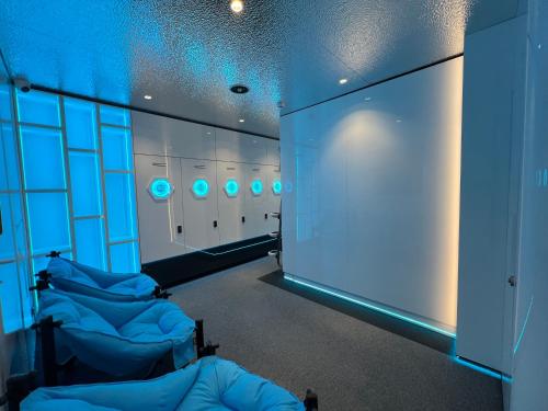 a locker room with blue lights on the wall at Galaxy inn Luxury hostel in center in Yerevan