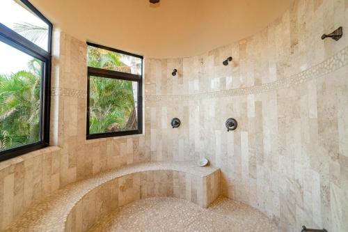 a bathroom with a large shower with a window at 2010 - Villa Allure in Valerio Martínez