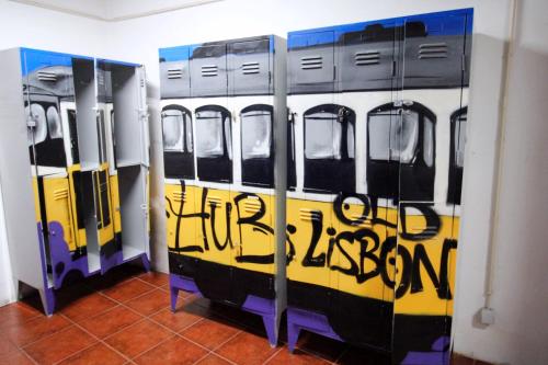 a room with three trains with graffiti on the doors at WOT New Lisbon in Lisbon