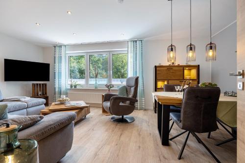 a living room with a table and a dining room at Ferienwohnung Landradler in Bad Karlshafen