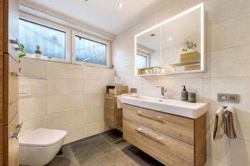 a bathroom with a sink and a toilet at Ferienwohnung Landradler in Bad Karlshafen