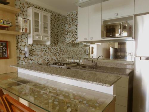 a kitchen with a sink and a counter top at Porto Real Apartment Angra in Mangaratiba